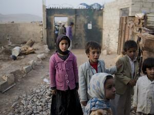 Yemeni children stand outside the Huwaiti home, as the mother of Mohammad and Ahmad mourns. She lost both of her sons, ages 17 and 14, who were selling produce on the side of the road, to a Saudi-led coalition airstrike in Al Joob village. (Alex Potter)