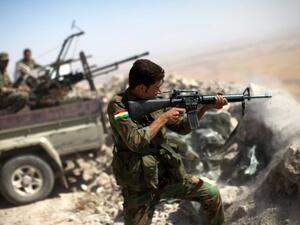 An Iraqi Kurdish Peshmerga fighter fires at Daesh militants during 2014 clashes on the outskirts of Mosul. (AFP/Jean Marc Mojon)