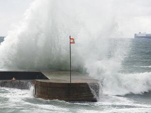 Waves crash into a Lebanese flag during a storm.  While scores of young Lebanese are scrambling abroad for better opportunities, perhaps the key to a better future is to stay home, writes Anthony Elghossain. (AFP/File)