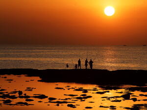A breathtakingly beautiful land of contradictions - Lebanese men enjoy a peaceful moment fishing during sunset outside the northern city of Tripoli, where armed clashes have broken out between Sunni and Shia residents. (AFP/Joseph Eid)
