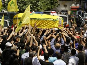 Members and supporters of Lebanon's Shiite Hezbollah movement carry the coffin of their comrade Saleh Ahmad Sabbagh during his funeral in the southern port city of Sidon on May 22 (Mahmoud Zayyat / AFP)