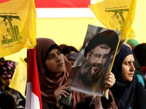 Lebanese women wave Hezbollah flags while holding a picture of the movement's chief Hassan Nasrallah in Mashghara in the western Bekaa Valley on May 25 (MahmoudZayyat / AFP)