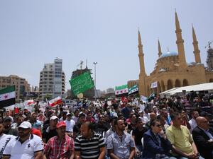 People hold Syrian flags during a protest against the involvement of the Shiite movement Hezbollah in fighting in Syria on June 9, 2013 on the Martys square in the Lebanese capital Beirut (Anwar Amro/ AFP)