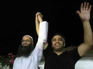 Lebanese Sunni Muslim Salafist cleric Sheikh Ahmed al-Assir (L) holding the hand of Lebanese singer Fadel Shaker during a small concert where he sang Muslim hymns in the southern city of Sidon (Mahmoud Zayyat / AFP)