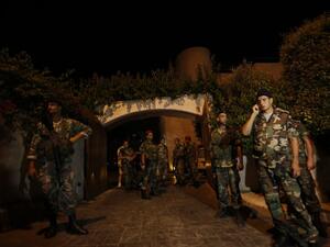 LEBANON, BAABDA : Lebanese army troops secure a private residence where one of two rockets fired from an unknown location exploded in the early hours of August 2, 2013, just metres from an entrance to the presidential palace in Baabda, around eight kilometres southeast of the Lebanese capital Beirut. AFP PHOTO / ANWAR AMRO