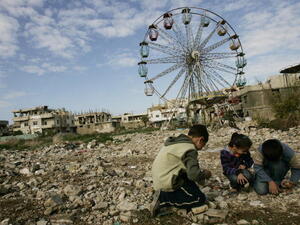  Palestinian children collect stones to be thrown at their friends as they play a 'war' game in the Palestinian refugee camp of Nahr al-Bared, 2009.  JOSEPH EID/AFP/Getty Images)