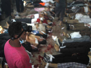 A man looks at bodies laid out in a make shift morgue after Egyptian security forces stormed two huge protest camps at the Rabaa al-Adawiya and Al-Nahda squares where supporters of ousted president Mohamed Morsi were camped (AFP/MOSAAB EL-SHAMY)