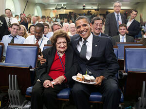 President Barack Obama presents cupcakes with a candle to Hearst White House columnist Helen Thomas in honor of her birthday in the James Brady Briefing Room, on Aug. 4, 2009. Thomas, who turned 89, shares the same birthday as the President, who turned 48. (Source: Official White House Photostream/Pete Souza)