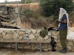 جندي اسرائيلي يقرأ في التوارة قرب موقع العديسة حيث وقعت المواجهة/ا.ف.ب