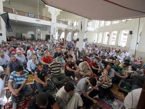 LEBANON, Tripoli : People perform the Friday prayer on August 31, 2013, inside Al-Salam mosque that was targeted with a car bomb a week ago in the northern Lebanese port city of Tripoli. AFP PHOTO STR