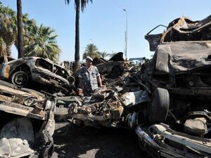 LEBANON, Tripoli : A Lebanese soldier inspect burnt vehicles on August 24, 2013 on the site of a bombing outside Al-Taqwa mosque the day before in the northern city of Tripoli. AFP PHOTO IBRAHIM CHALHOUB