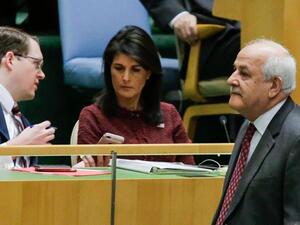 Riyad H. Mansour, (R) Palestine's Ambassador to the United Nations walks pass by US Ambassador to the UN Nikki Haley as he attends the General Assembly for the vote on Jerusalem, on December 15, 2017, at UN Headquarters in New York. (AFP)