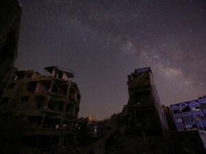 The underground layered graves of war-torn Douma, a Damascus suburb, mirror the bombed-out apartment buildings of the deceased, writes Omar Youssef Souleimane.  (AFP/Sameer al-Doumy)