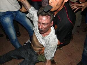 Libyan civilians help an unconscious man, identified by eyewitnesses as US ambassador to Libya, Chris Stevens, at the US consulate compound in Benghazi, following an overnight attack on the building. Stevens and three of his colleagues were killed. (AFP PHOTO/STR)