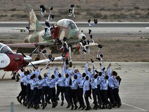 Israeli pilots throw their hats in the air as they celebrate at their graduation ceremony. (AFP)