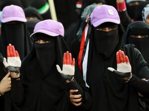 Women, whose hands are painted with Yemen's colours, take part in a rally marking the first anniversary of the ouster of autocratic leader Ali Abdullah Saleh. (AFP PHOTO/ MOHAMMED HUWAIS)