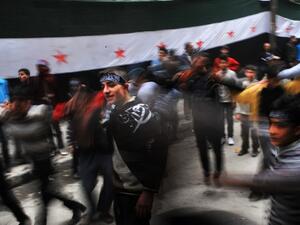 Syrian protestors dance during an anti-regime demonstration in the northern city of Aleppo on March 22, 2013. EU foreign ministers mulled a contested push by Britain and France to lift or amend a Syria arms embargo to help tip the balance in the country's more than two-year conflict. (AFP PHOTO/BULENT KILIC)