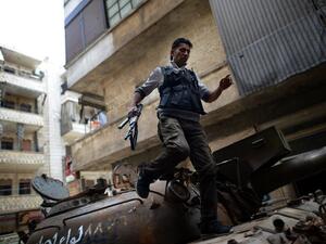 A Syrian rebel patrols an area in the Sheikh Maqsud district of the northern Syrian city of Aleppo, on Thursday. (AFP PHOTO / DIMITAR DILKOFF)