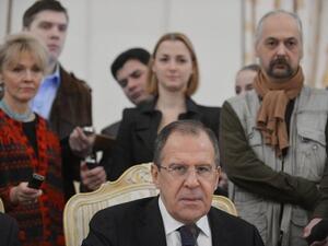 Russia's Foreign Minister Sergei Lavrov is circled by journalists in Moscow on Friday, as he meets his visiting Egypt counterpart Mohamed Amr on the Syrian crisis. (AFP PHOTO / NATALIA KOLESNIKOV)