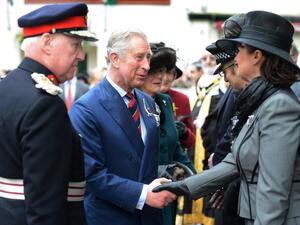 Prince Charles, Prince of Wales, and Camilla, Duchess of Cornwall, shake hands with well-wishers as they leave St John The Baptist City Parish Church in Cardiff. (AFP PHOTO / POOL / ADRIAN SHERRATT)