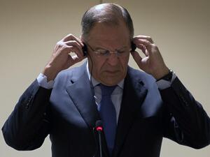 Russian Foreign Minister Sergei Lavrov straightens the headphones during a press conference in Rio de Janeiro, Brazil on June 11 (Vanderlei Almeida / AFP)