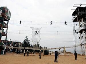 Syrian cadets perform military exercises during their graduation ceremony in Damascus (AFP PHOTO / HO / SANA)