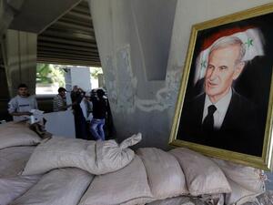 A picture of late Syrian president, Hafez al-Assad, father of current President Bashar al-Assad, seen at an army checkpoint in Damascus. (AFP PHOTO/JOSEPH EID)