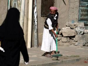 A Yemeni man sweeps a street during the "Sharik (participate), My contribution builds Yemen" cleaning campaign in the capital. (AFP PHOTO/ MOHAMMED HUWAIS)