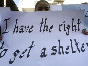 A Palestinian girl, who along with other families who fled the Yarmuk Palestinian refugee camp in the Syrian capital of Damascus, holds up a sign during a rally in front on the United Nations Relief and Works Agency (UNRWA) offices in the Palestinian refugee camp of Ain El-Helweh on the outskirts of the southern Lebanese city of Sidon on Tuesday (AFP PHOTO/MAHMOUD ZAYYAT)