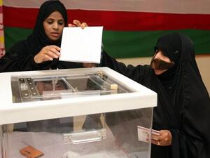 An Omani woman casts her vote at a polling station in the al-Khaburah district, on Saturday. (AFP)