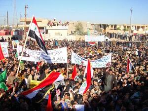 Iraqi protesters hold banners during a demonstration demanding the ousting of Prime Minister Nouri al-Maliki on Friday. (AFP)