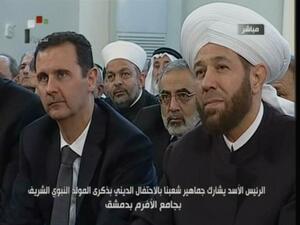 An image grab taken from the state-run Syrian TV shows Syria's President Bashar al-Assad (L) siting next to Syrian Grand Mufti Ahmed Hassun. (AFP PHOTO/SYRIAN TV) 