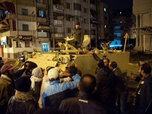 Egyptian protestors shout at a soldier standing in an armored personnel carrier as they demonstrate in the streets of the canal city of Port Said. (AFP PHOTO / STR)