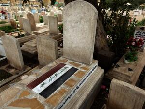 The old Iraqi flag is painted on a tomb of a man killed in 2006 in the Martyrs Cemetery outside the Sunni Abu Hanifa mosque in the Sunni stronghold of Adhamiya. (AFP PHOTO/PATRICK BAZ)