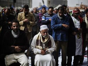 Egyptian anti-government protestors perform Friday prayers ahead of a demonstration on Friday. (AFP PHOTO/GIANLUIGI GUERCIA)