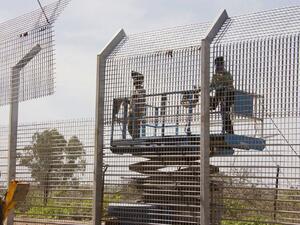 Laborers work at the construction site of a border fence along Israel's border with Syria in the Golan Heights. (AFP PHOTO/JACK GUEZ)