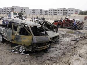 Iraqi emergency personnel and civilians gather around the site of a car bomb explosion near the outskirts of the south Iraq city of Basra, on March 17, 2013, killing 10 people and wounding 16, the head of the Basra provincial council security committee said. (AFP PHOTO/STR)