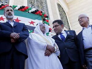 Moaz al-Khatib (L) with the Qatari delegation at the inauguration ceremony. (AFP PHOTO/KARIM SAHIB)