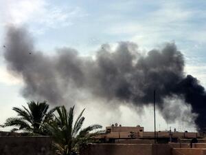 Smoke rises from the site of a car bomb near the Imam Mahdi Islamic Center in Baghdad on March 29, 2013. A series of bombs near Shia mosques targeting worshippers attending weekly prayers killed at least 15 people, the latest in a spike in unrest ahead of Iraq's first polls since 2010. (AFP PHOTO / SABAH ARAR)
