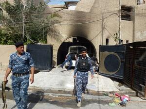 Iraqi policemen inspect the premisses of the al-Mustaqbal (The Future) newspaper in the Karrada district of Baghdad on April 2, 2013, following an attack. (AFP PHOTO/SABAH ARAR)