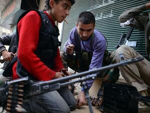 Rebel fighter load their weapons in the Sheikh Maqsud neighborhood in Aleppo on April 4, 2013. (AFP PHOTO / DIMITAR DILKOFF)