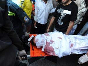A slain Muslim Brotherhood protester is carried away in Cairo on July 27. AFP / FAYEZ NURELDINE