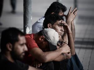 Bahraini men sit in the village of Sitra, south of Manama, on August 2, 2013. (AFP)