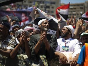 EGYPT, Cairo : Members of the Muslim brotherhood and supporters of ousted Egyptian President Mohammed Morsi attend a sit-in outside the Rabaa al-Adawiya mosque on the first day of Eid al-Fitr celebrations on August 8, 2013 in Cairo. (AFP)
