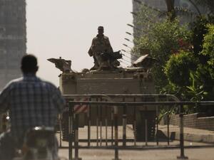 An Egyptian soldier keeps watch from the top of an army armoured personnel carrier at the entrance of Tahrir Square on August 18, 2013 in Cairo. (AFP)