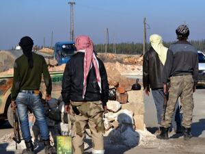 Rebel fighters man a checkpoint close to Jabal al-Zawiyaa in Idlib province on January 6, 2014. [AFP]