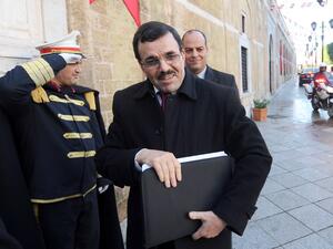 Tunisia's Islamist premier Ali Larayedh arrives at Kasbah Palace in Tunis to submit his resignation to Tunisian President Moncef Marzouki on January 9, 2014.  [AFP]