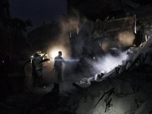 Syrians look for survivors amidst the rubble of a building targeted by a missile in the al-Mashhad neighbourhood of Aleppo. (AFP PHOTO / STR)