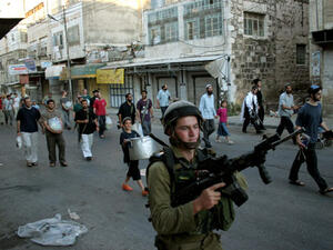Jewish soldiers guard the 700 Israeli settlers living in the center of Hebron. Under international law, building settlements in Hebron and other West Bank territories is illegal (Courtesy of Mamoun Wazwaz/Maan Images)