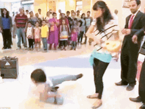 The man lies on the floor after being hit round the head with a small guitar. Not an ideal end to any proposal. But was the video real or fake? (YouTube)